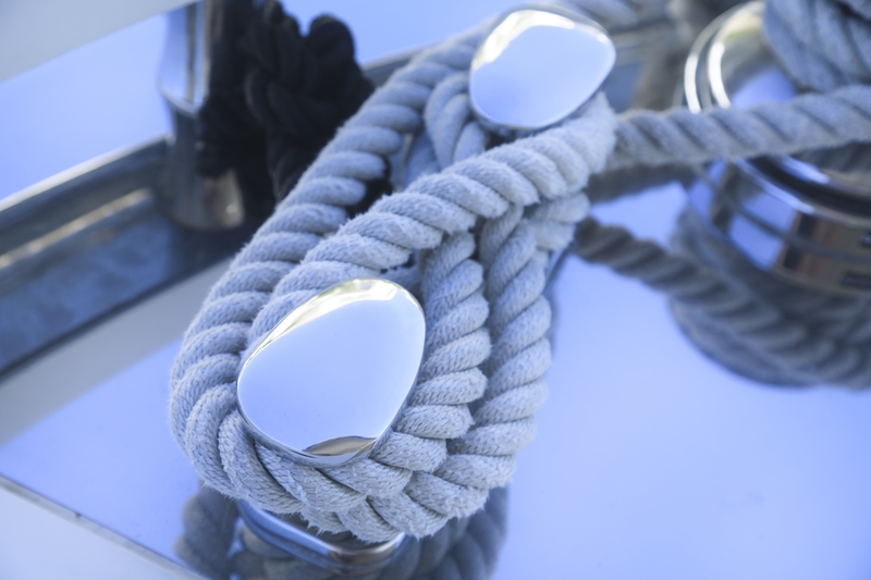 Rope tied around a polished cleat on a sailboat